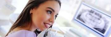 woman comparing teeth shades | Dentist Wylie, TX