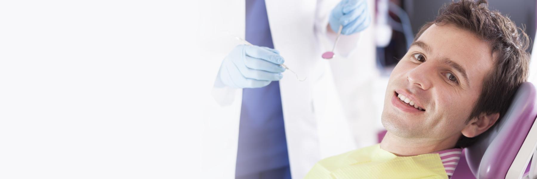 man in dental chair after getting emergency dental care in wylie